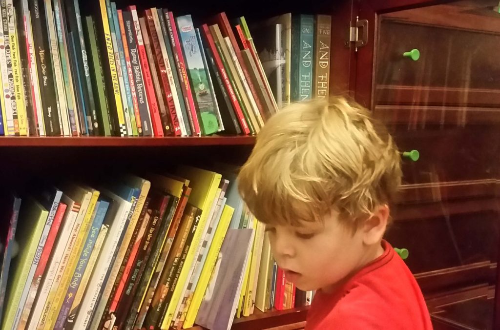 child and bookshelves